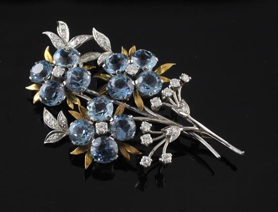 A 1960s 18ct white and yellow gold, diamond and blue topaz floral spray brooch, 2.25in.